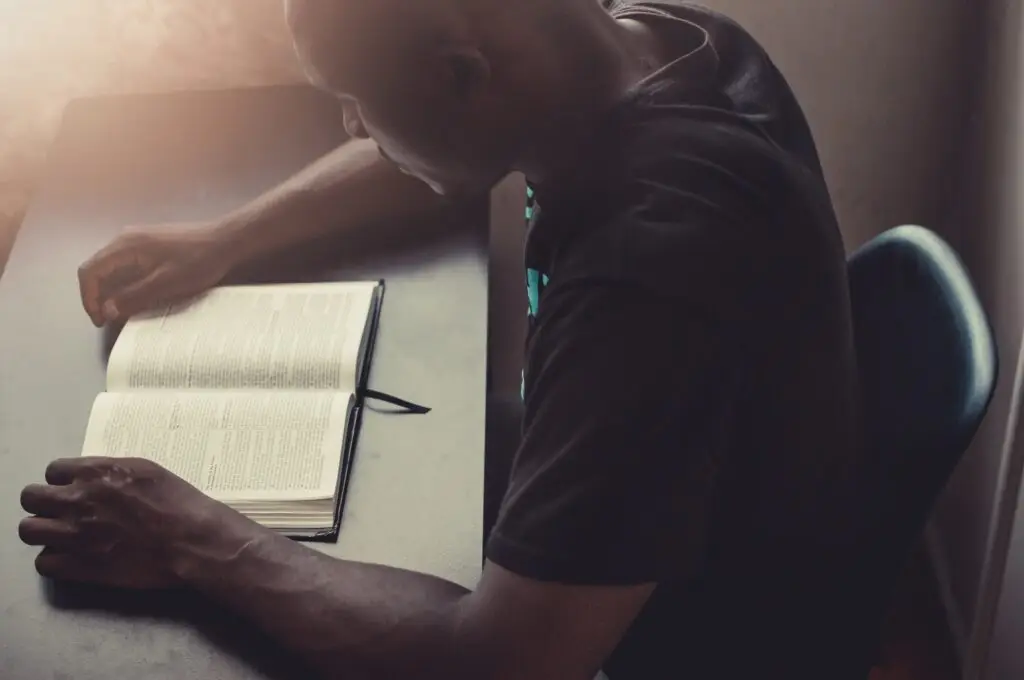 Young man reading his book on the desk